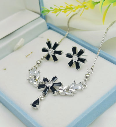 Silver-toned jewelry set featuring a necklace and matching stud earring